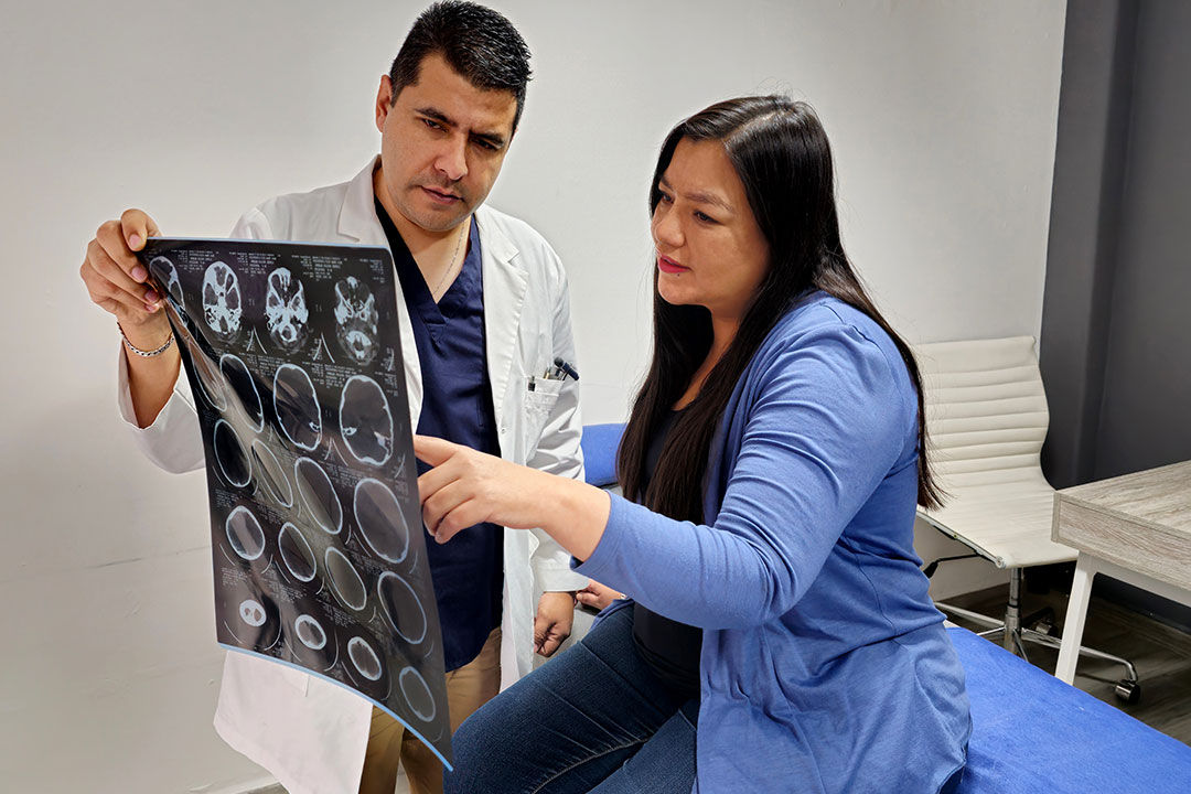 Patient and doctor reviewing x-ray.